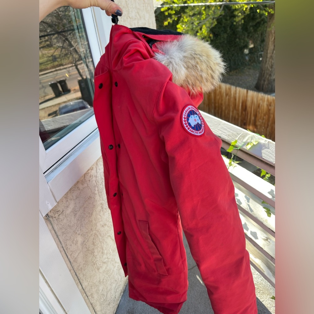 Red women’s medium Canada Goose long down coat with coyote fur lined hood
